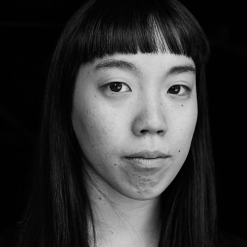 Black and white portrait of a person with black long hear with fringe