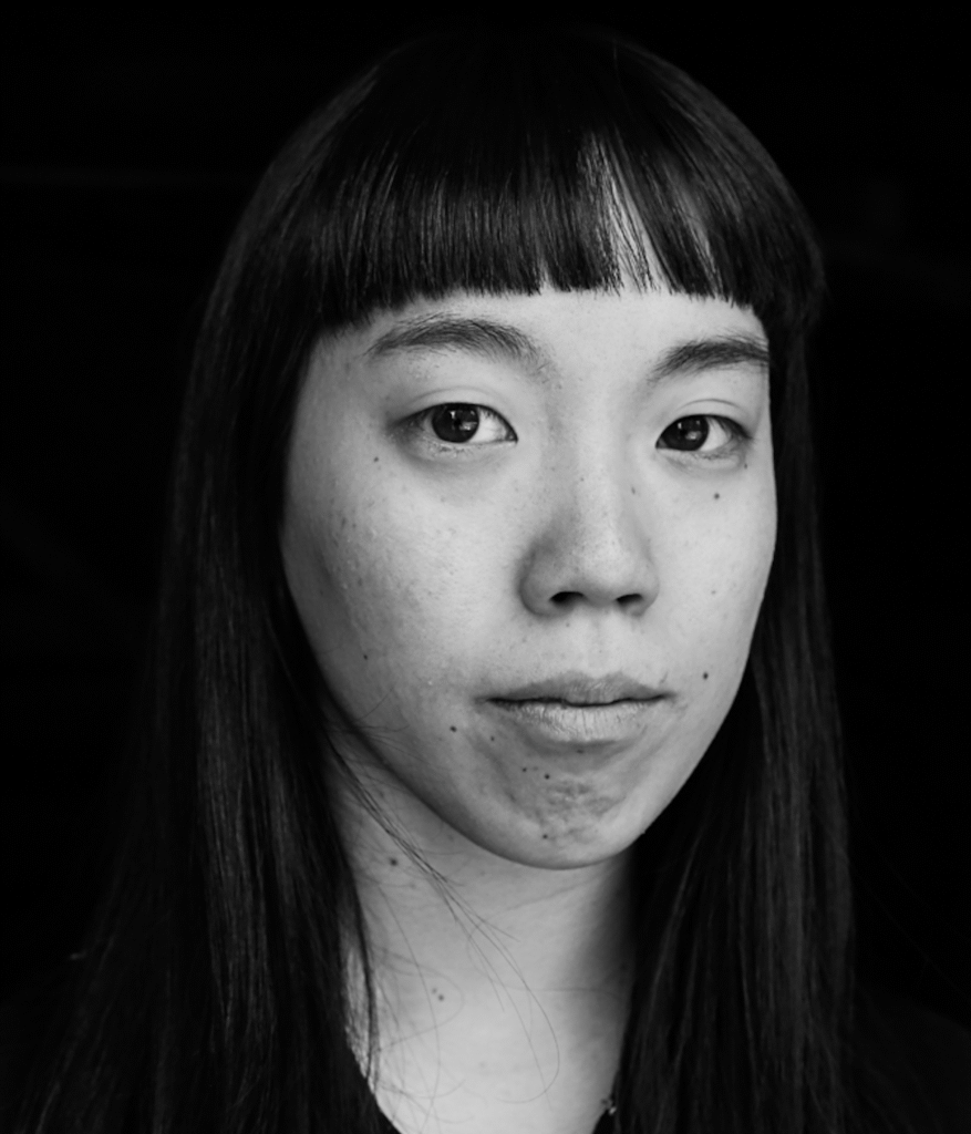 Black and white portrait of a person with black long hear with fringe